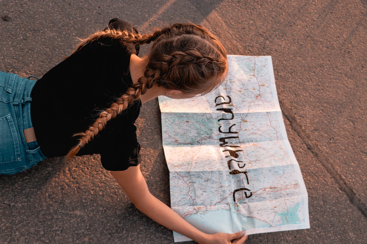 Image of a person looking at a map with the word 'anywhere' drawn on the map